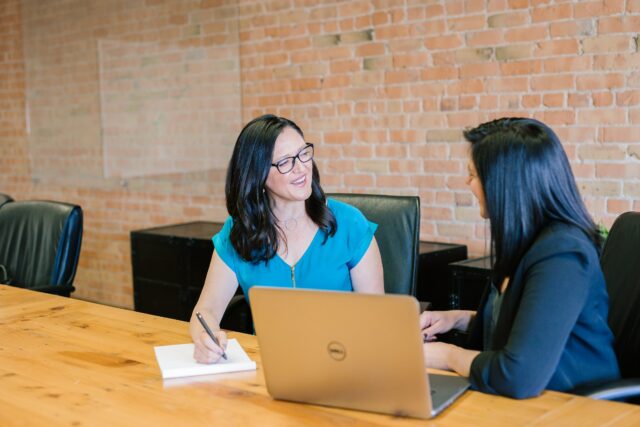 Two women in a meeting room