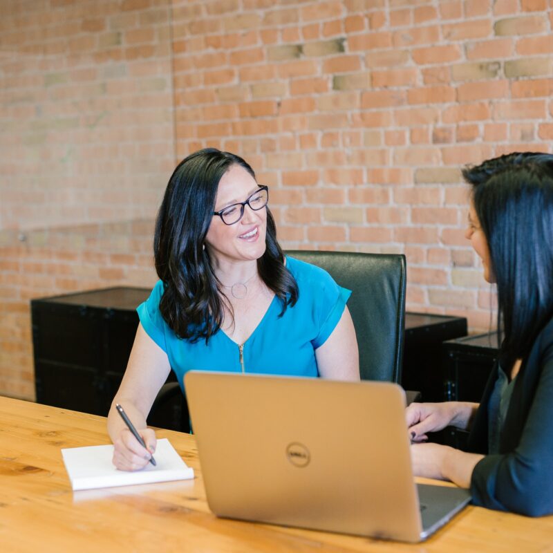 Two women in a meeting room